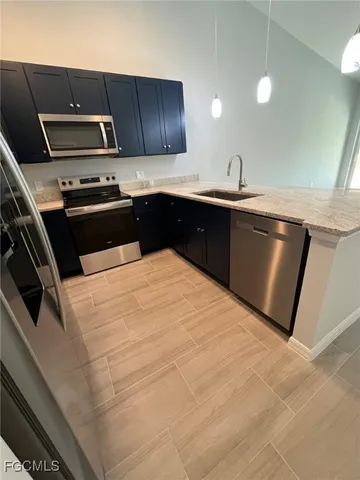 a kitchen with a sink and stainless steel appliances