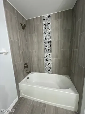 a bathroom with a bathtub and shower