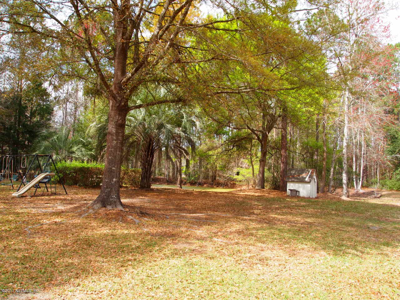 54676 Cravey Road Callahan, FL 32011 - Photo 5 of 5 a backyard of a house with lots of green space and fountain