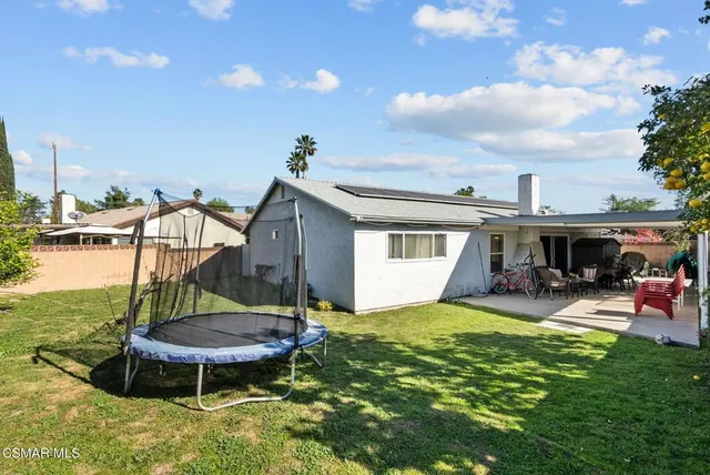 a view of a house with backyard porch and sitting area