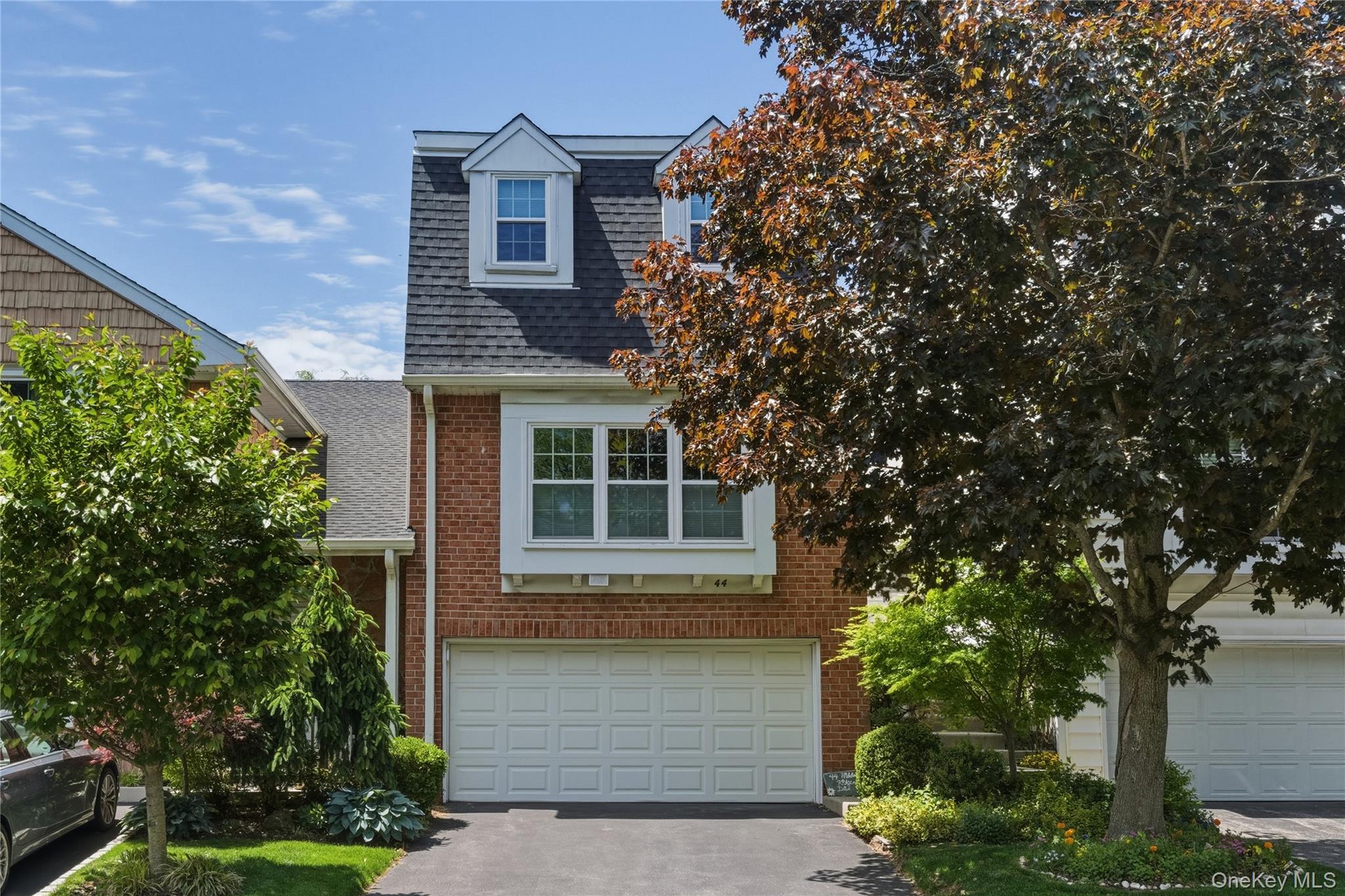 front view of a house with a tree