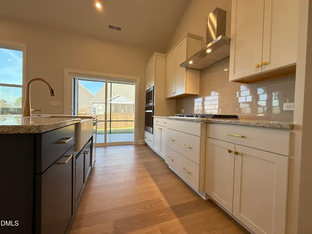 a kitchen with stainless steel appliances granite countertop a sink and cabinets