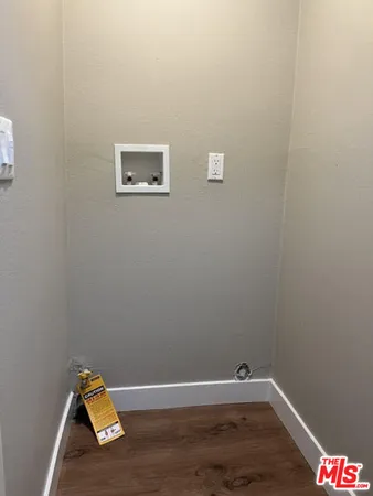 a view of a room with wooden floor and a window