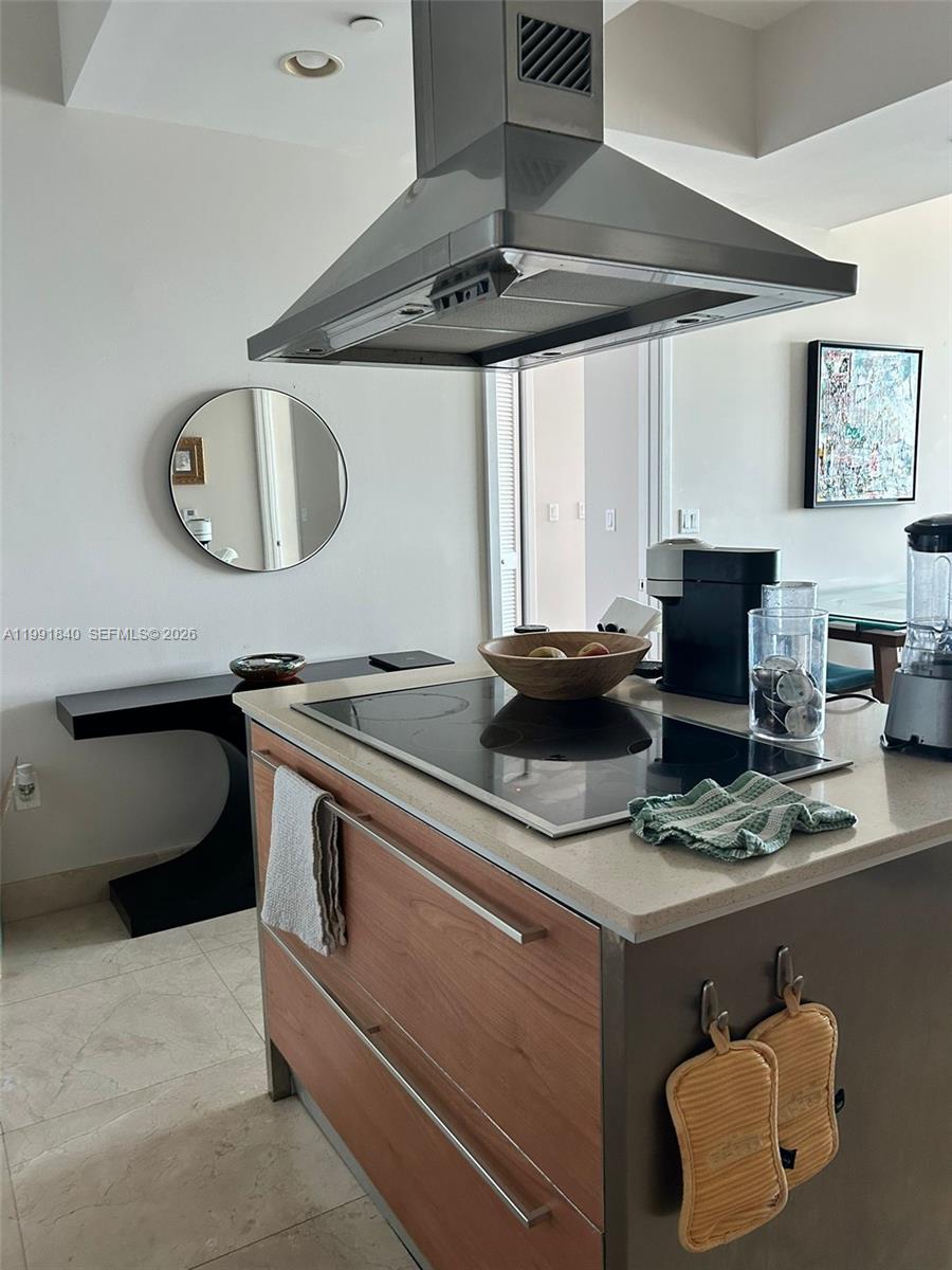 218 Southeast 14th Street, Unit TS303 Miami, FL 33131 - Photo 12 of 16 a kitchen with a stove and a chair