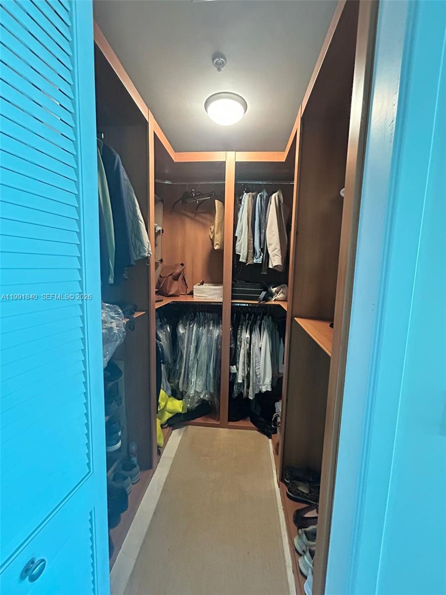 218 Southeast 14th Street, Unit TS303 Miami, FL 33131 - Photo 16 of 16 a view of walk in closet with clothes and shoes