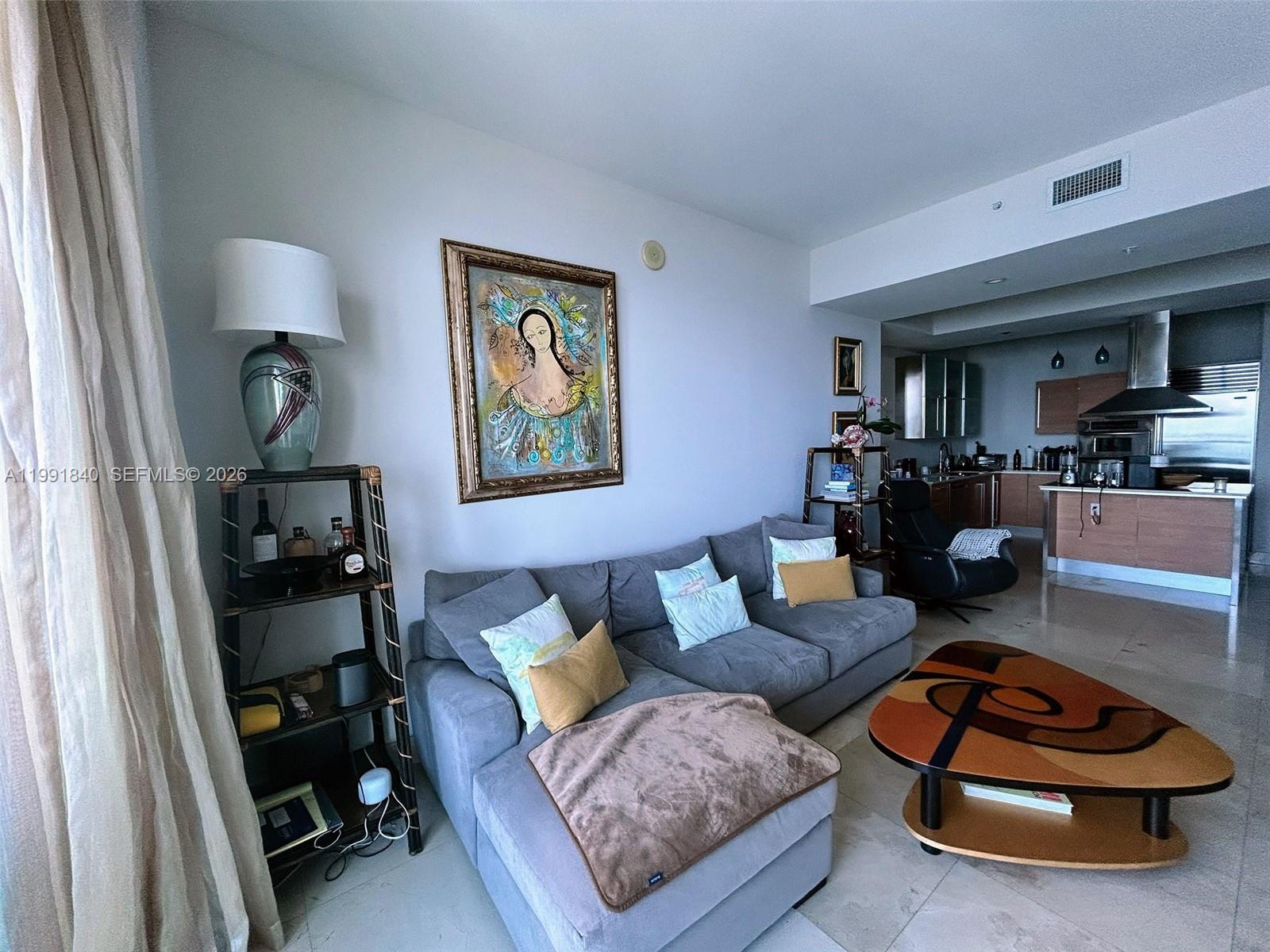 218 Southeast 14th Street, Unit TS303 Miami, FL 33131 - Photo 2 of 16 a living room with furniture and a wooden floor