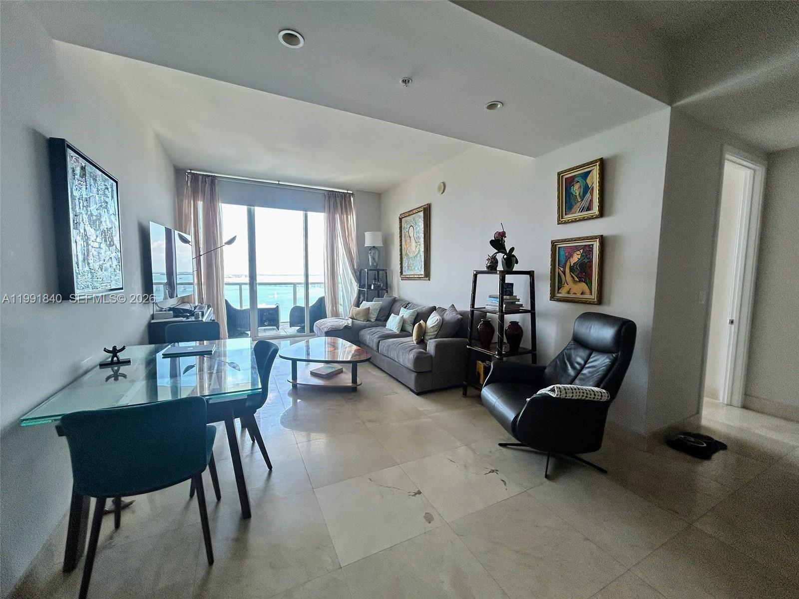 218 Southeast 14th Street, Unit TS303 Miami, FL 33131 - Photo 4 of 16 a living room with furniture and a window