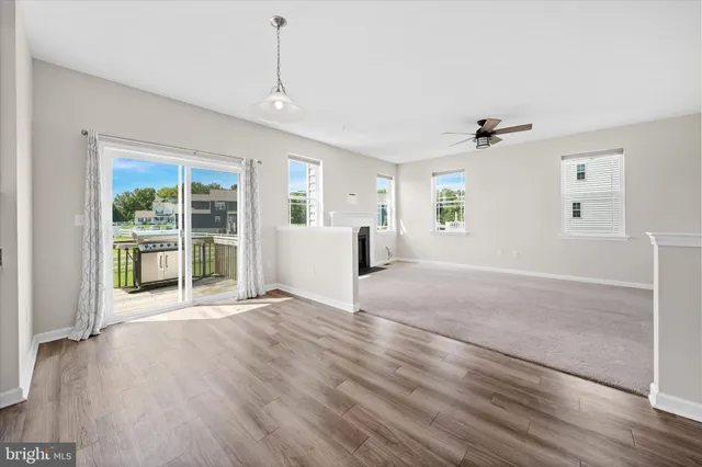 a view of empty room with a fireplace and window
