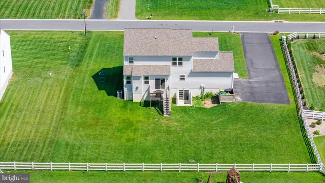 a front view of a house with garden and trees