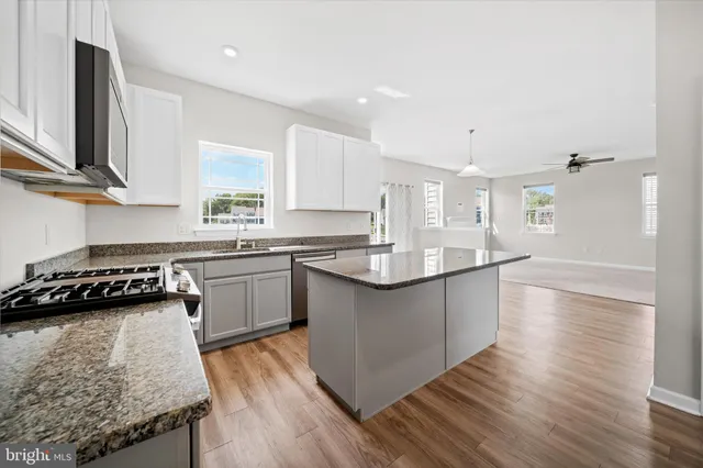 a kitchen with a sink stove top oven and microwave
