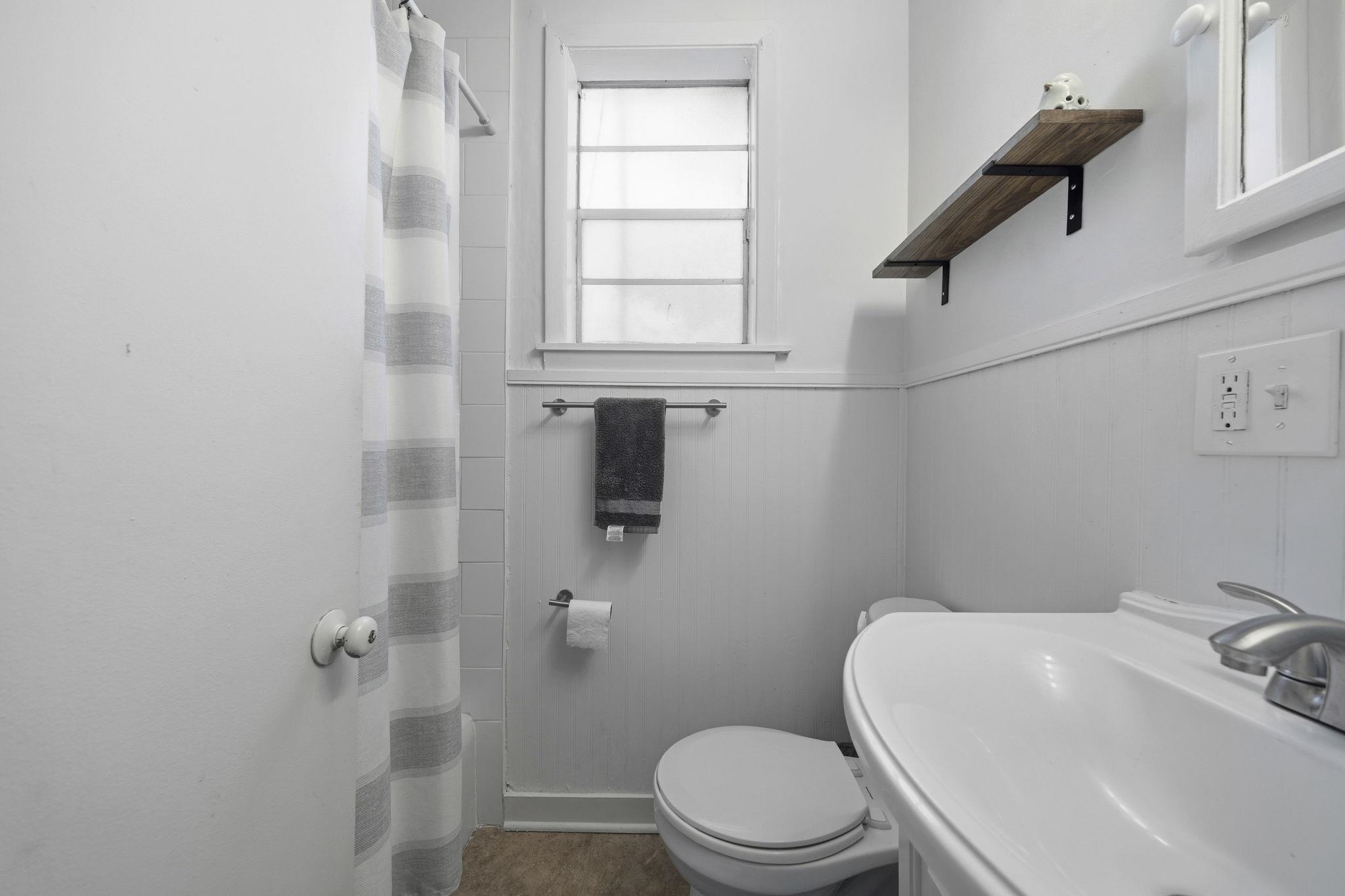 471 South Reese Street Memphis, TN 38111 - Photo 12 of 22 a white toilet sitting next to a bathroom sink