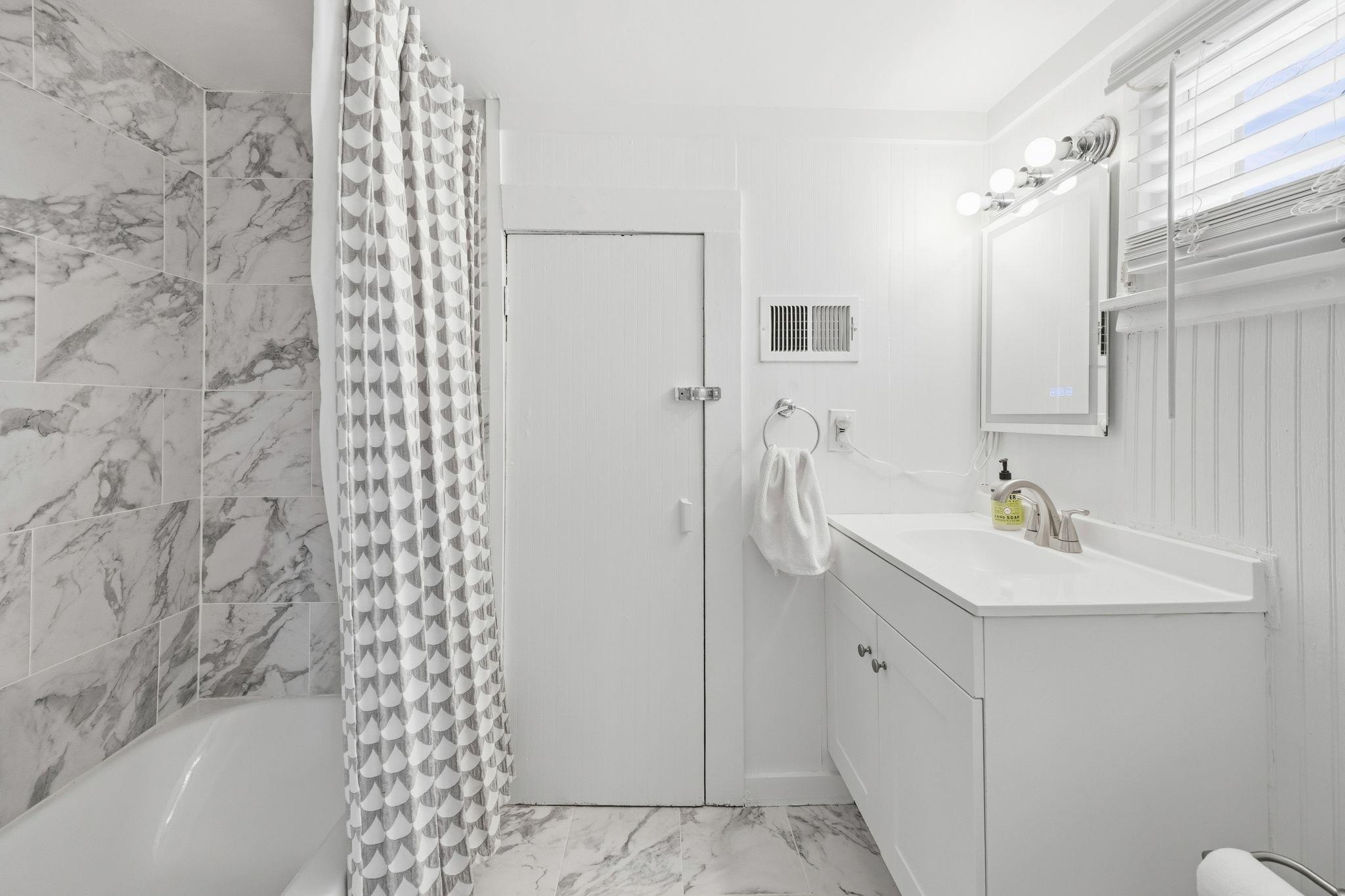 471 South Reese Street Memphis, TN 38111 - Photo 15 of 22 a bathroom with a sink a toilet and shower