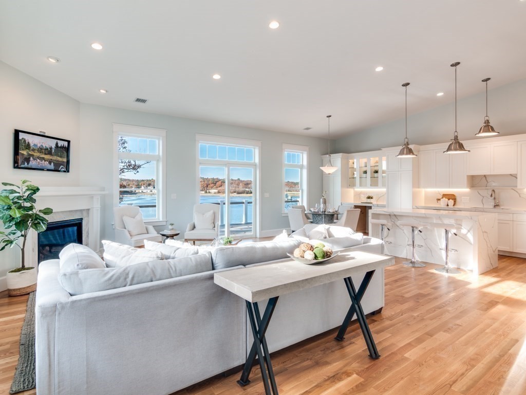 8 Stanwood Point, Unit A Gloucester, MA 01930 - Photo 5 of 21 a living room with fireplace furniture and a wooden floor