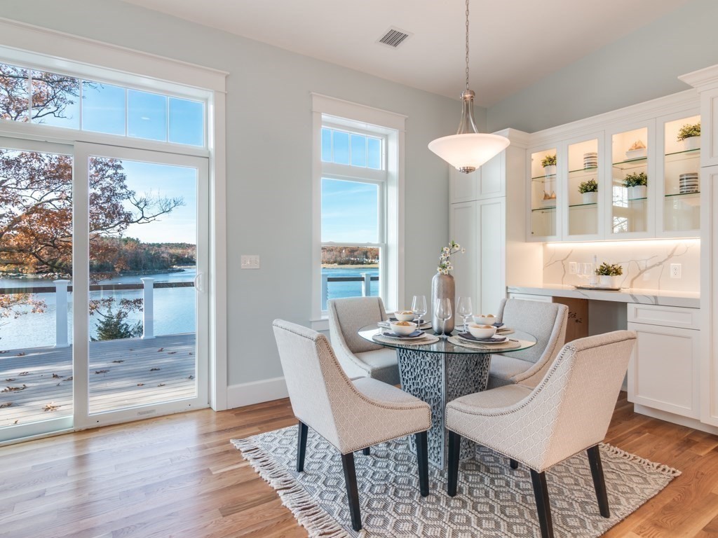 8 Stanwood Point, Unit A Gloucester, MA 01930 - Photo 6 of 21 a view of a dining room with furniture wooden floor and a chandelier