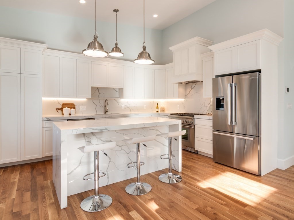 8 Stanwood Point, Unit A Gloucester, MA 01930 - Photo 8 of 21 a kitchen with stainless steel appliances granite countertop a sink a refrigerator and a stove