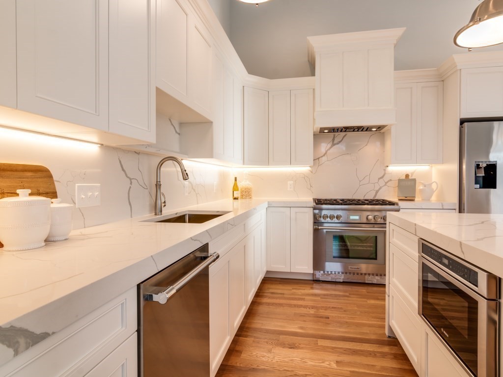 8 Stanwood Point, Unit A Gloucester, MA 01930 - Photo 9 of 21 a kitchen with a sink stove top oven and refrigerator
