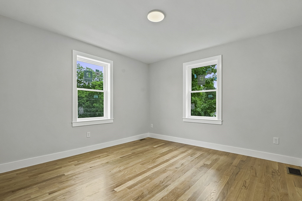 4 Mayhew Street Framingham, MA 01702 - Photo 15 of 42 an empty room with wooden floor and windows