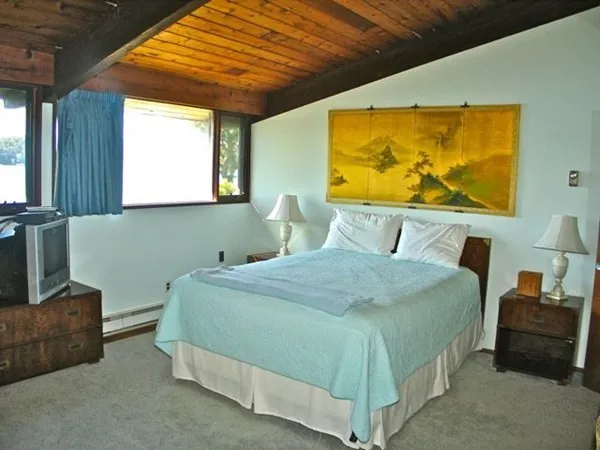 a bedroom with a bed and window