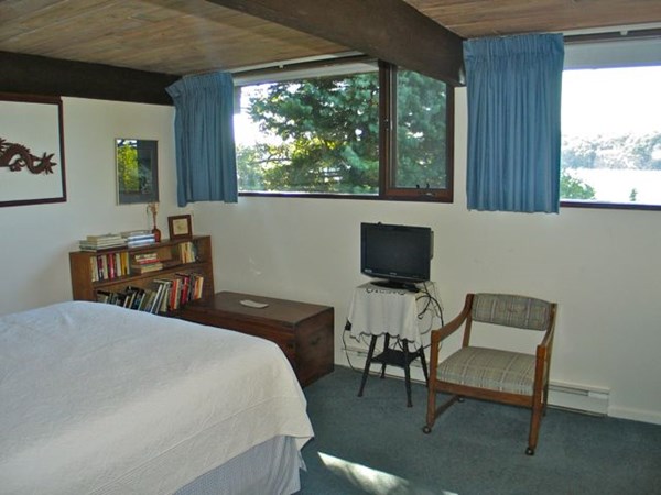 291 Barnes Road Oak Bluffs, MA 02557 - Photo 16 of 30 a bedroom with a bed and large windows