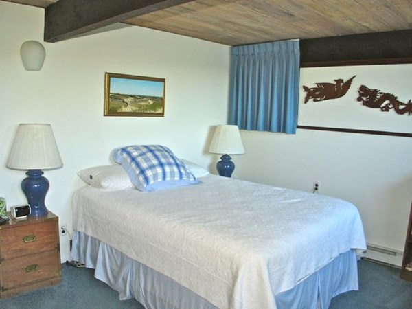 291 Barnes Road Oak Bluffs, MA 02557 - Photo 17 of 30 a bedroom with a bed and a lamp on dresser