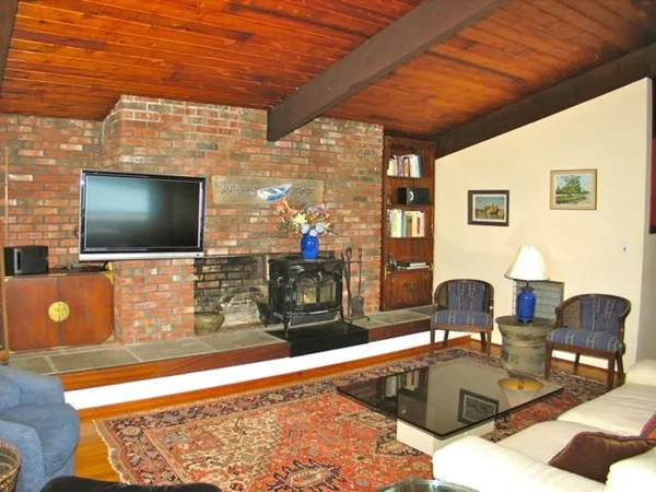 a living room with a flat screen tv and outdoor view