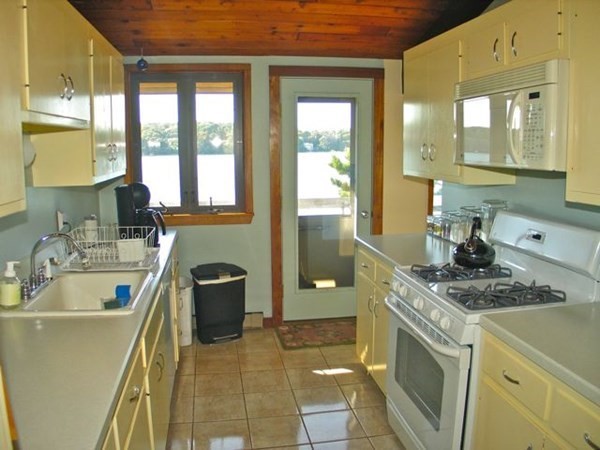 291 Barnes Road Oak Bluffs, MA 02557 - Photo 6 of 30 a bathroom with a granite countertop sink a toilet a mirror and bathtub