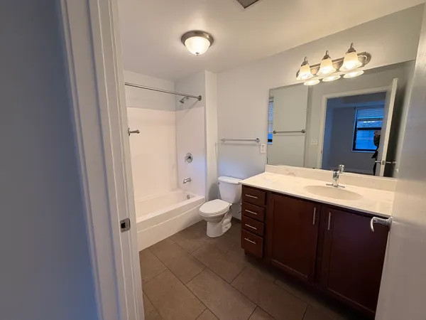 a bathroom with a double vanity sink mirror and toilet
