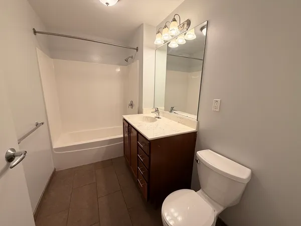 a bathroom with a sink vanity mirror and toilet