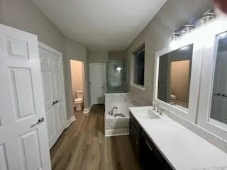 a bathroom with a double vanity sink and mirror with shower