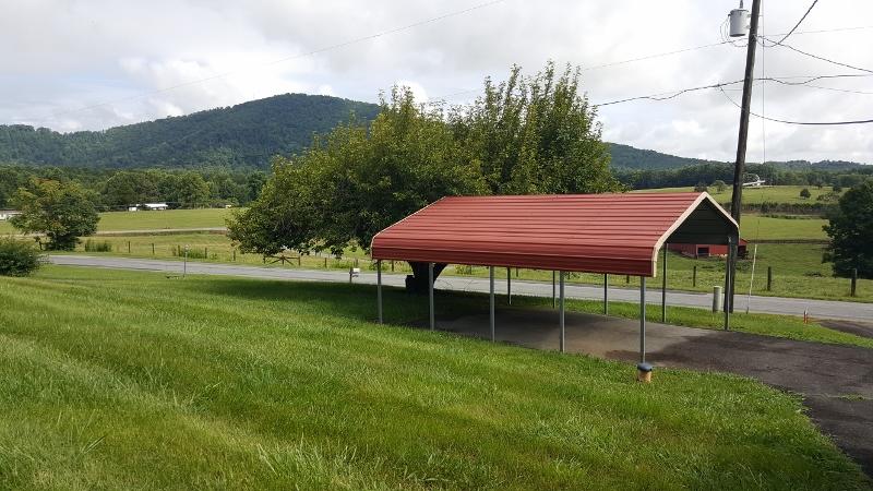2713 Beech Mountain Road Ferrum, VA 24088 - Photo 4 of 24 a backyard of a house with table and chairs