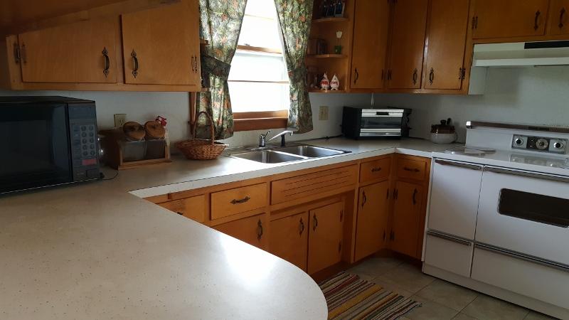 2713 Beech Mountain Road Ferrum, VA 24088 - Photo 7 of 24 a kitchen with stainless steel appliances granite countertop a sink a stove and cabinets