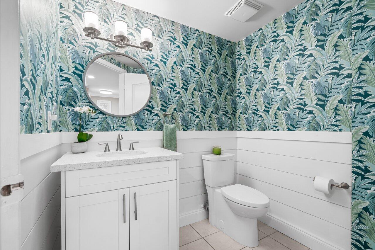 191 Southeast 20th Avenue, Unit 513 Deerfield Beach, FL 33441 - Photo 14 of 34 a bathroom with a sink a toilet and a mirror