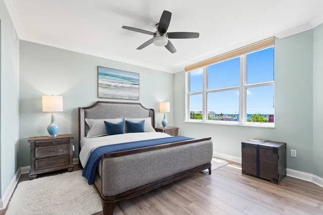 a bathroom with a granite countertop sink a large mirror and a bathtub