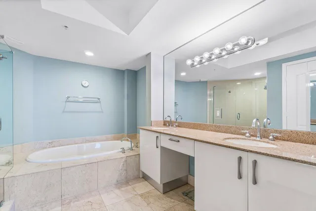 a bathroom with a bathtub and a shower