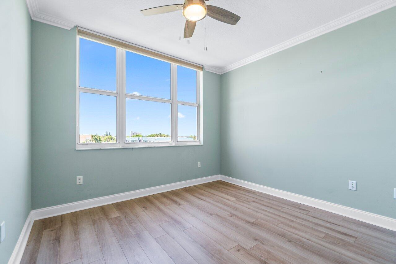 191 Southeast 20th Avenue, Unit 513 Deerfield Beach, FL 33441 - Photo 20 of 34 wooden floor in an empty room with a window