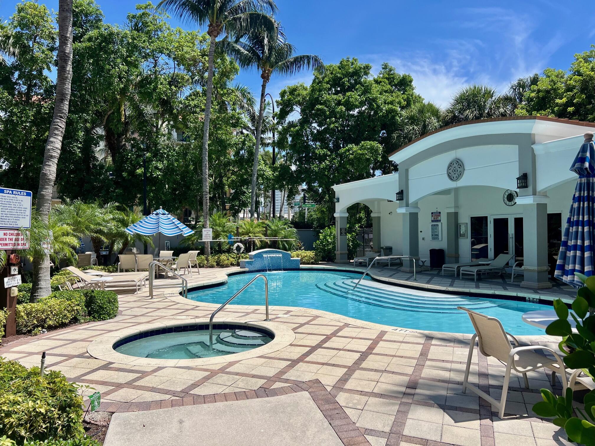 191 Southeast 20th Avenue, Unit 513 Deerfield Beach, FL 33441 - Photo 30 of 34 a view of a white house with swimming pool and sitting area
