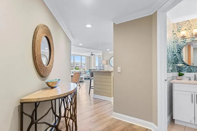 a view of a hallway with furniture and wooden floor