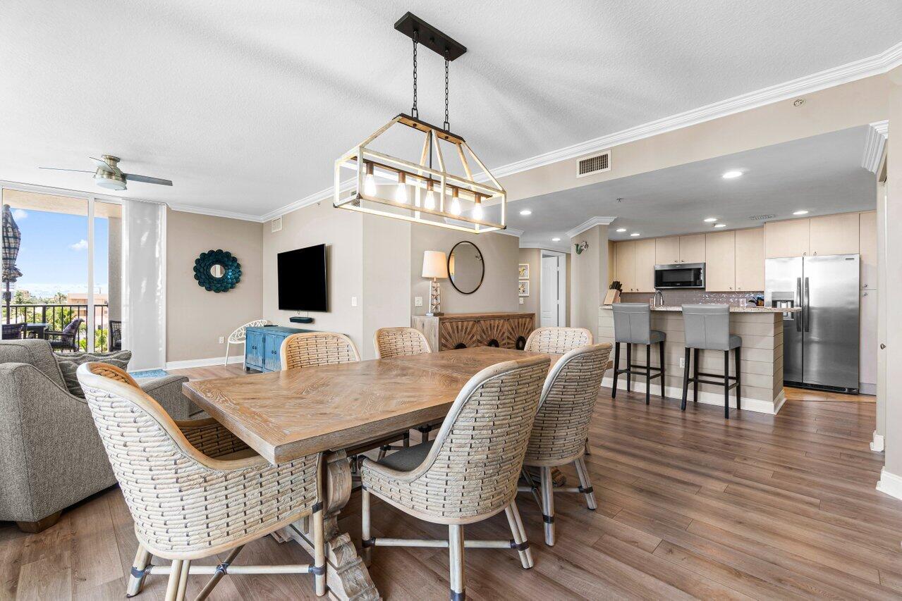 191 Southeast 20th Avenue, Unit 513 Deerfield Beach, FL 33441 - Photo 8 of 34 a view of a dining room with furniture and wooden floor