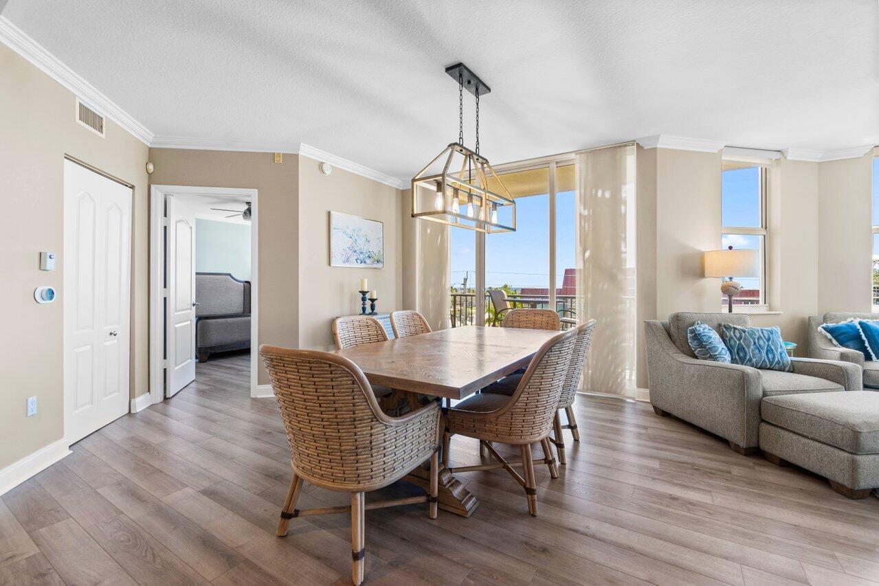 191 Southeast 20th Avenue, Unit 513 Deerfield Beach, FL 33441 - Photo 10 of 34 a dining room with furniture a chandelier and wooden floor