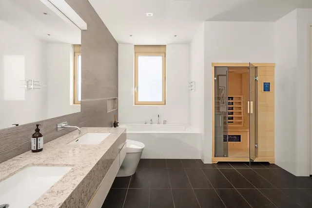 a bathroom with a double vanity sink mirror and toilet