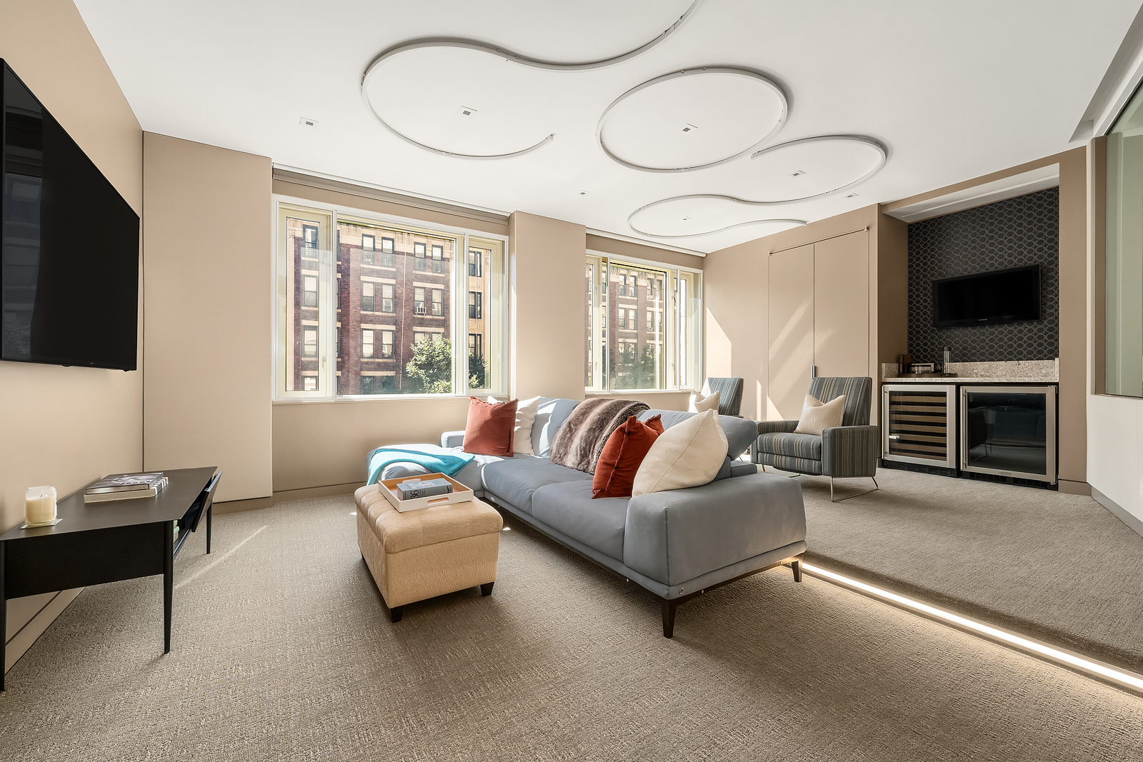 21 East 96th Street, Unit 3/4 Manhattan, NY 10128 - Photo 16 of 25 a living room with furniture a flat screen tv and a window