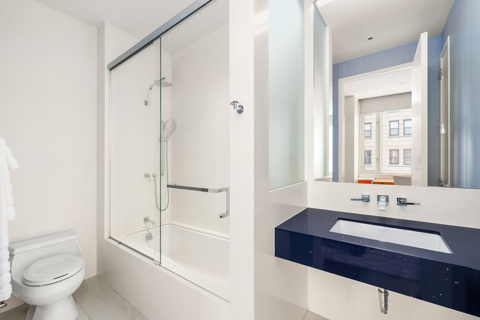 21 East 96th Street, Unit 3/4 Manhattan, NY 10128 - Photo 22 of 25 a bathroom with a sink a toilet and shower