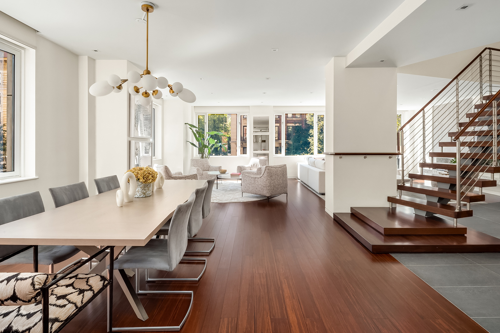 21 East 96th Street, Unit 3/4 Manhattan, NY 10128 - Photo 4 of 25 a view of a dining room with furniture window and wooden floor