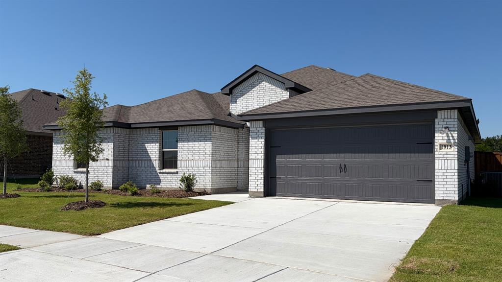 1913 Reveille Way Terrell, TX 75160 - Photo 1 of 35 Contemporary brick exterior featuring a multi-gabled roofline and an attached garage