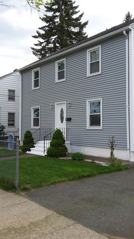 17 Kosciusko Street Springfield, MA 01151 - Photo 2 of 4 a front view of a house with a garden and yard