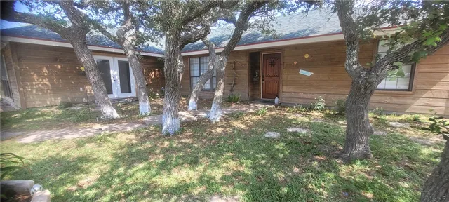 a view of a tree in front of a house