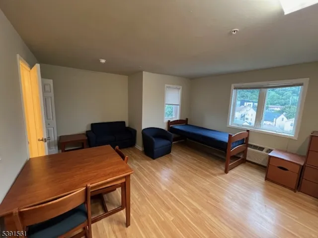 a living room with furniture a table and a large window