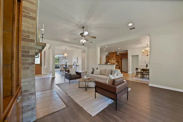 a living room with furniture and wooden floor