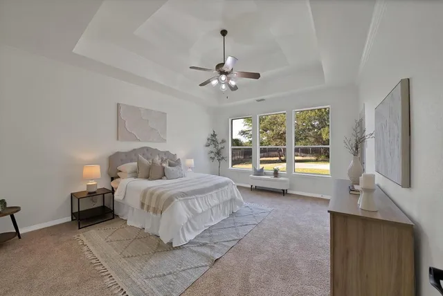 a spacious bedroom with a bed and a large window