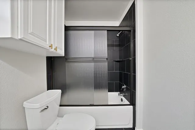 a bathroom with a toilet and a shower